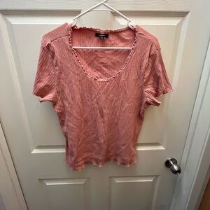Pink scoop neck shirt.